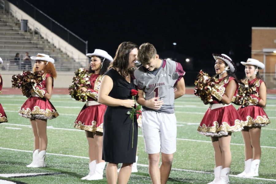 Freshman Holden Miller shares a moment with his mom on the field seconds before he's crowned Homecoming Lord.