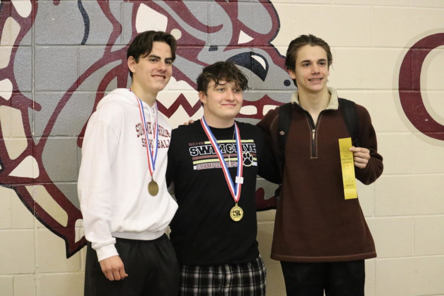 Junior Justin Sherwood, Senior Jayce Percival, and Junior Jay Robison pose with their awards at the regional diving meet. Sherwood placed 3rd, Percival placed 1st, and Robison placed 4th.