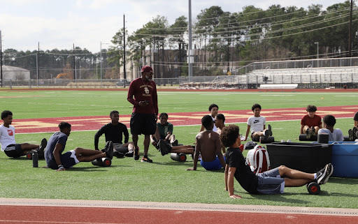 Coach Ervin gives his team a pep talk after practice.