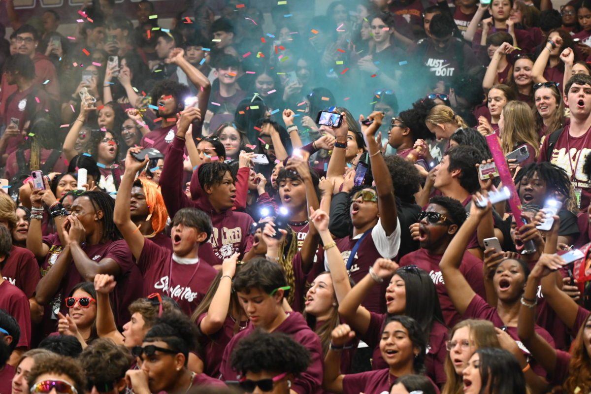 Sophomores scream and pop colored powder at the pep rally.  