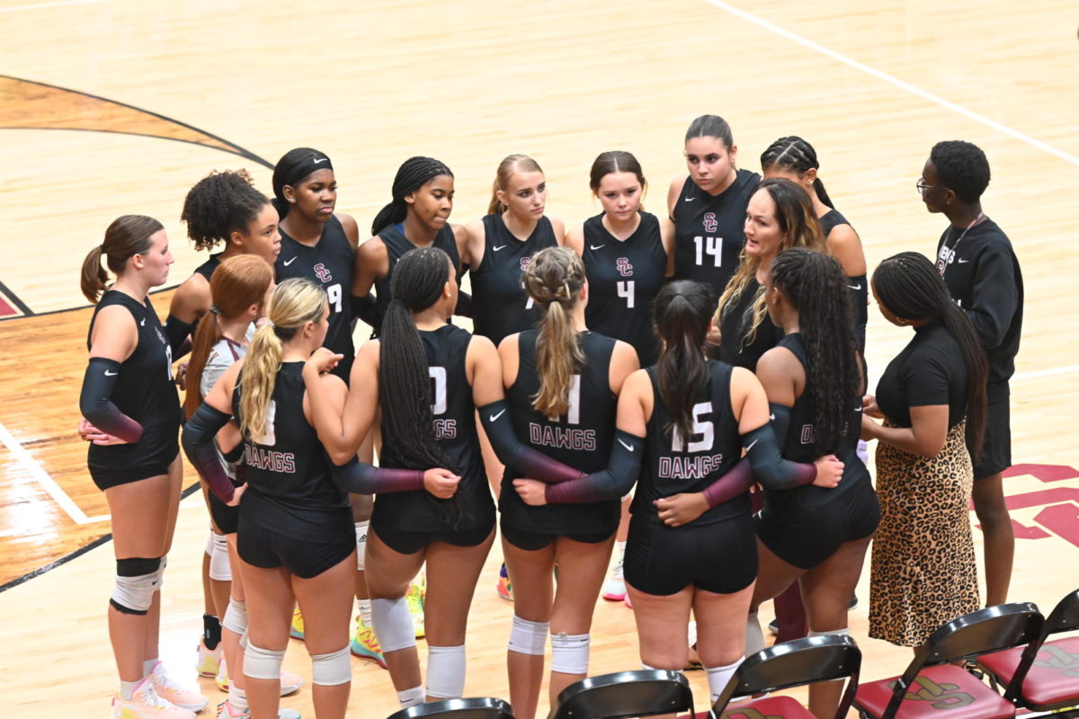 Varsity volleyball huddles up during their match on Aug. 22.