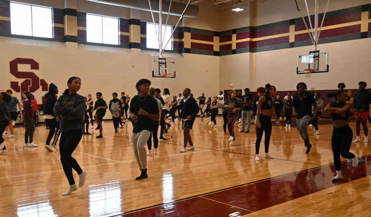 Starlettes and football players practice their dance.