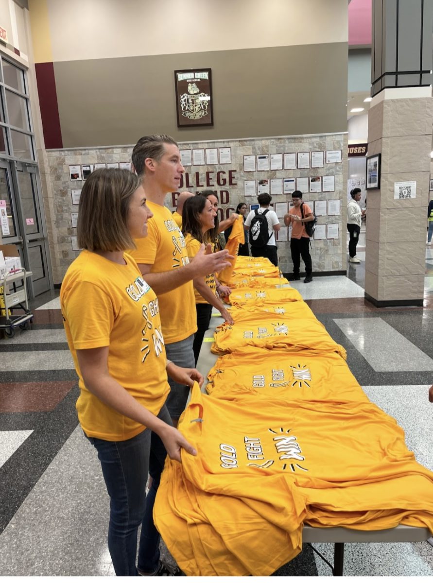 Gold fight win volunteers sell shirts during lunch 