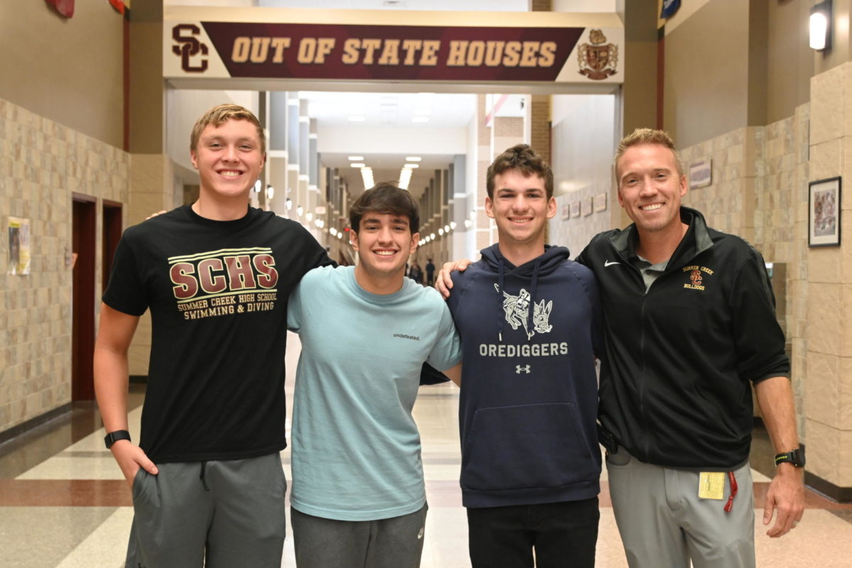 National Merit Semi-finalists Luke Stibrich, Matt Parks and Zach Houlton pose with Dr. Matthew Mahony.