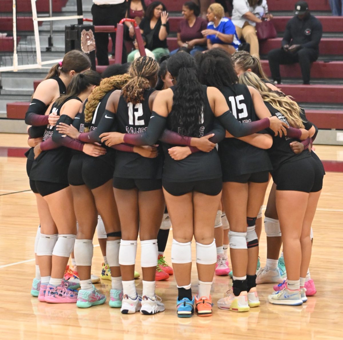 The varsity volleyball team huddles up between points during the game against Shadow Creek Ranch on Aug. 21.