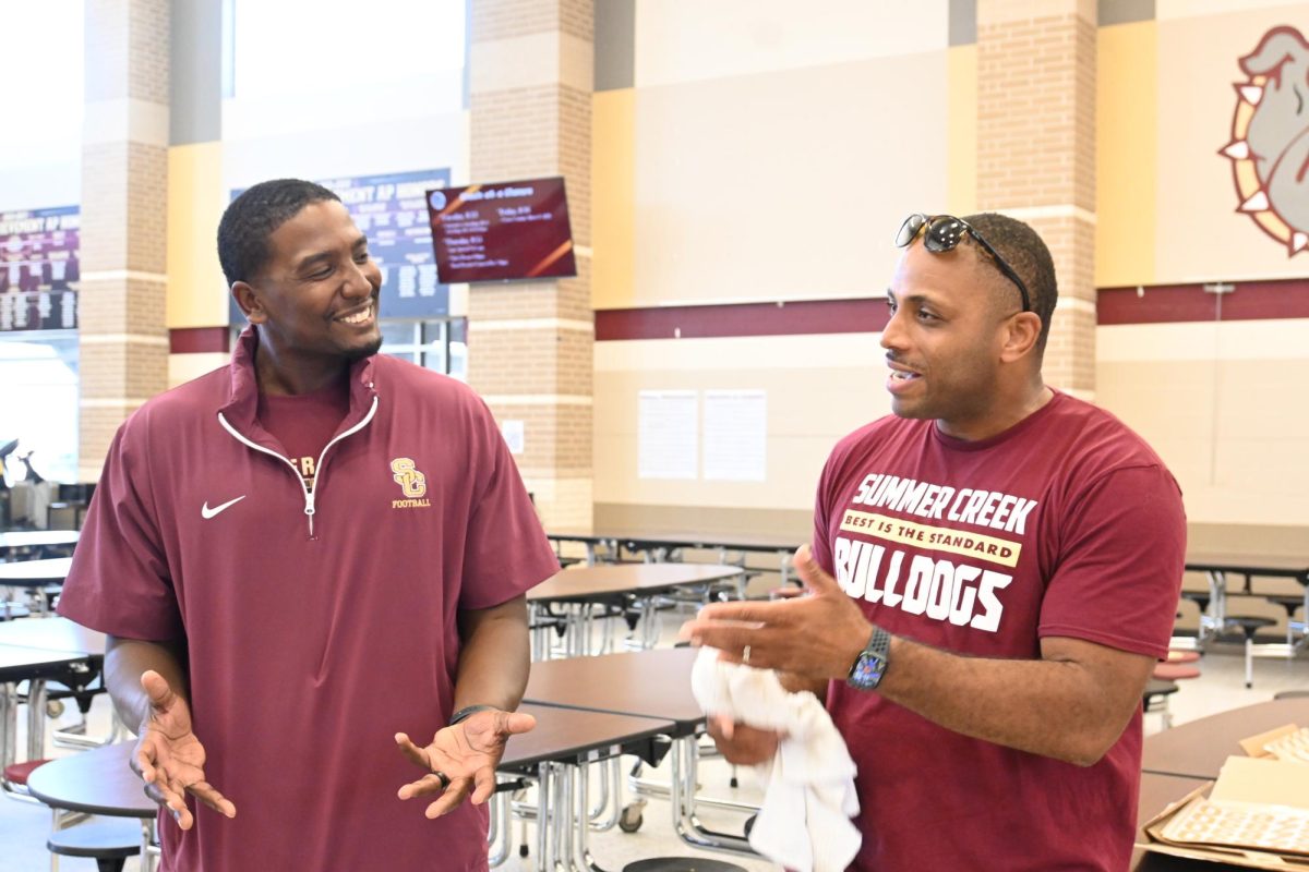 Football coach Danny Southall speaks with a parent at the Dads & Decals event on Aug. 24.