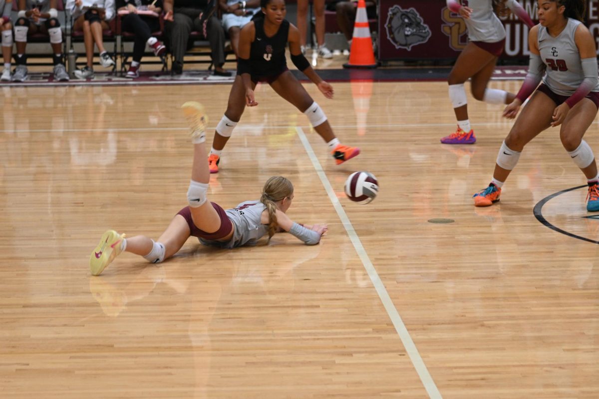 Junior Elli Burkhead dives for the ball