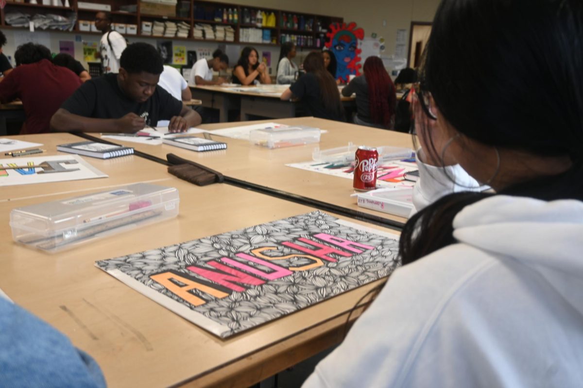 Sophomore Anusha Bajik sits with her portfolio after finishing work in her sketchbook.