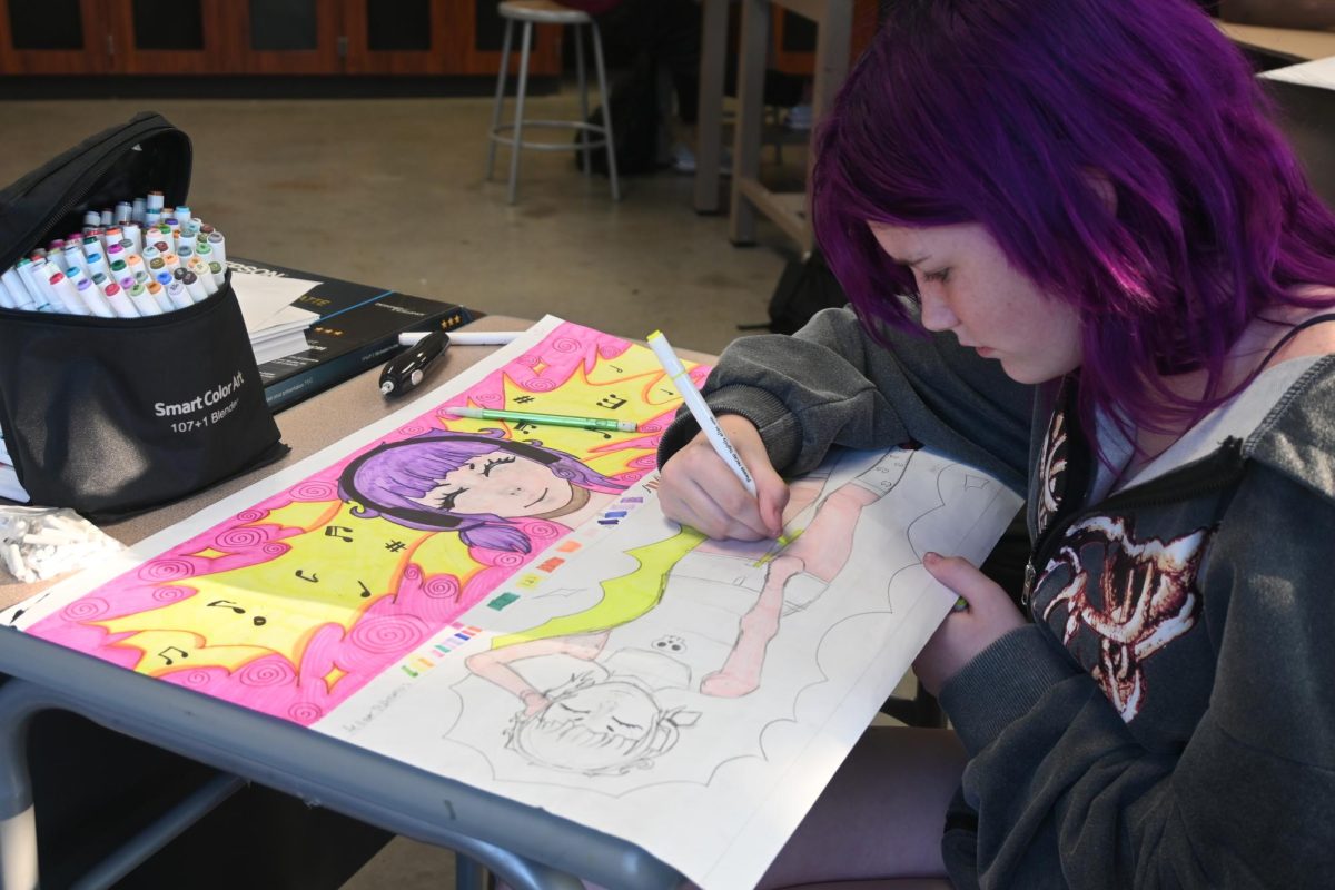 Freshman Aiden Polhemus adds detail to her colorful artwork. Aiden enjoys the community she has found in the art room. "I like most of the people in it. I love the community and how we have similar interests," Aiden said.