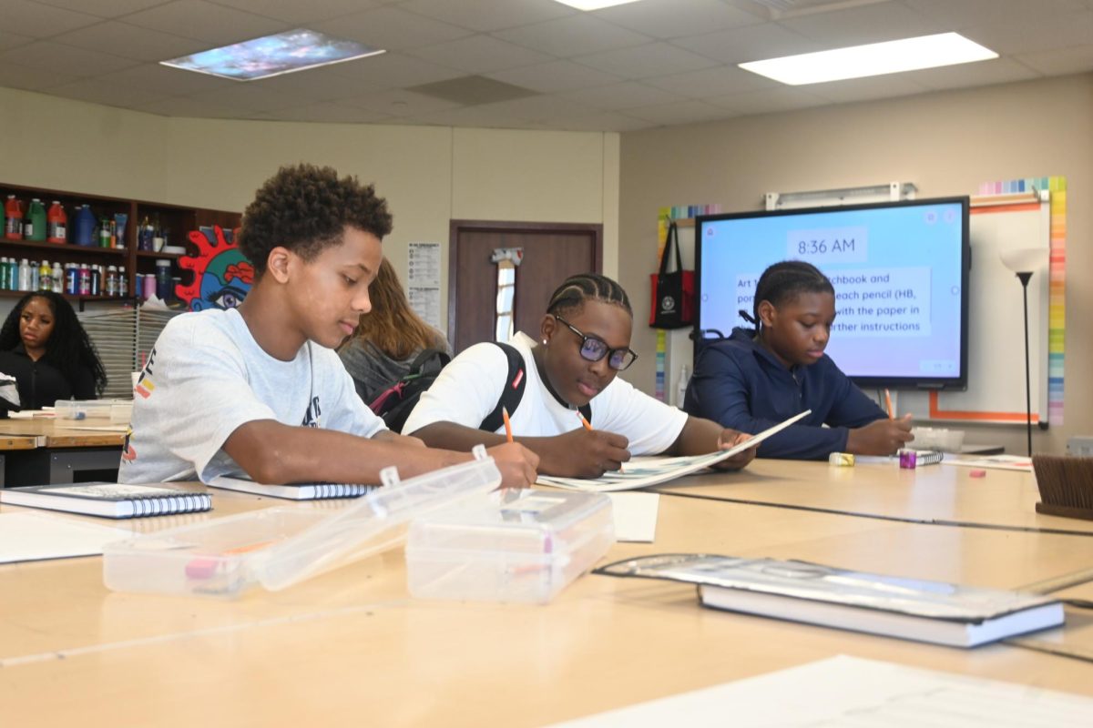 Freshmen Malkijah Perry, Bradley Deary and Kayden Patrick enjoy hanging out with their friends while completing their work in Ms. Hill's class.