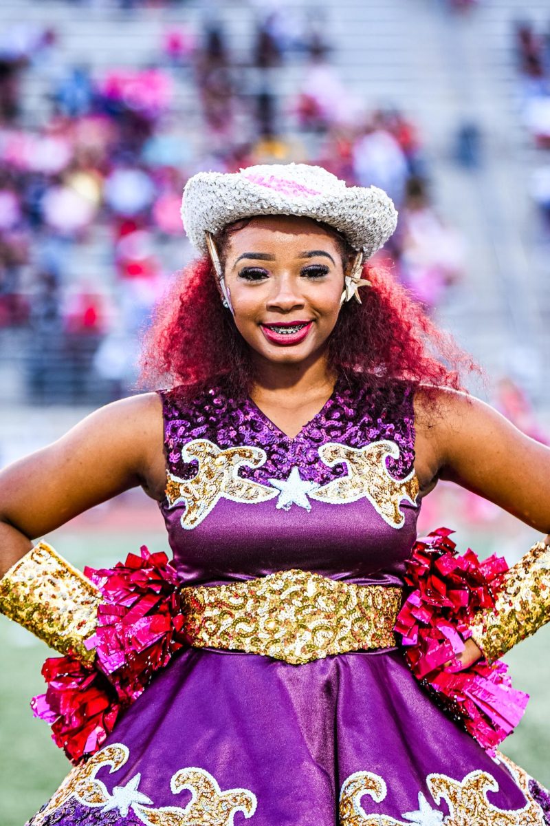 Senior Kylie Lewis stands in victory lines ahead of a football game.