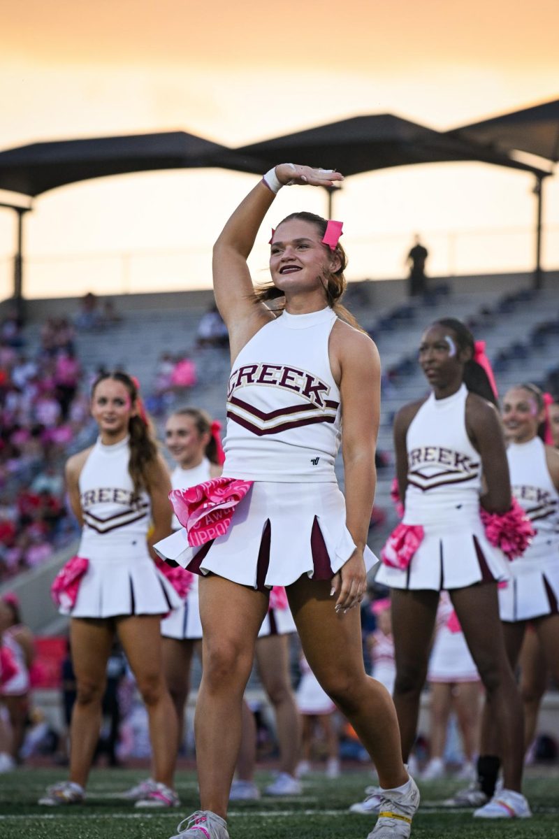 Senior Avery Walker waves to the crowd during cheerleader introductions at the Atascocita game on Oct. 3.
