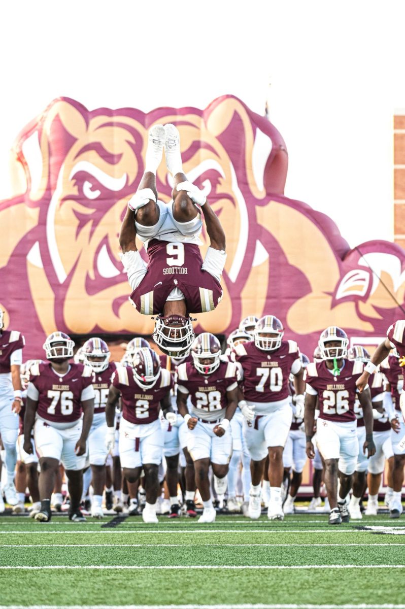 Senior Amontre Harris flips ahead of his team while the Bulldogs run out on the field during the home game against Lamar. 