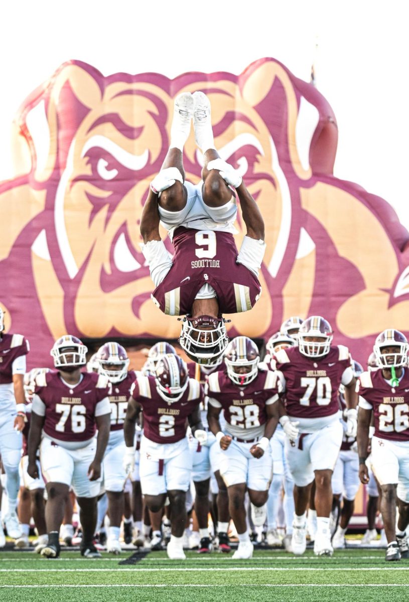 Senior Amontre Harris flips ahead of his team while the Bulldogs run out on the field during the home game against Lamar. 