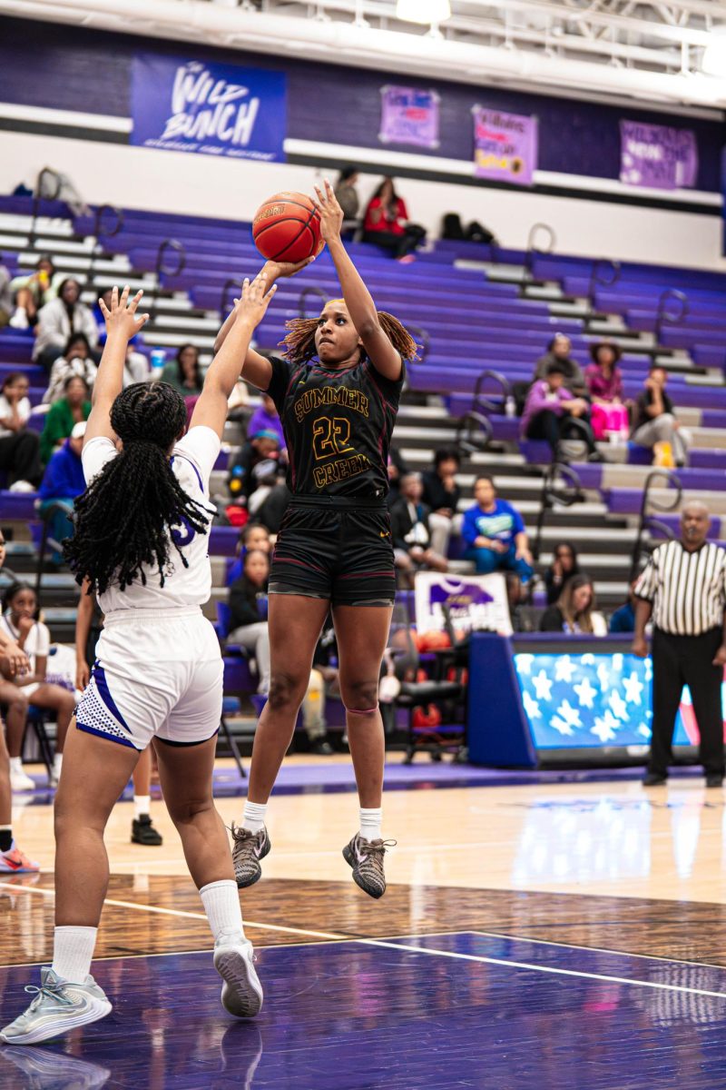 Junior Erin Newsom shoots a contested shot at the free throw line. 