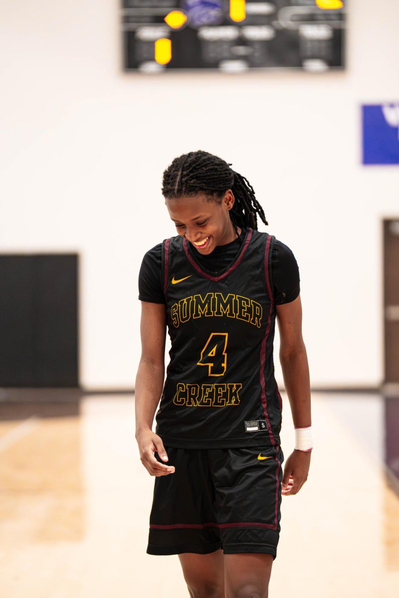Senior Kennedy Simpson smiles during a break in the game. "I keep my positive energy just by being grateful to be able to play basketball and I know I'm a leader so people feed off my energy."