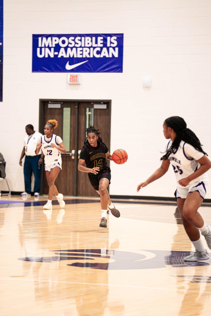 Junior Addison Martin brings the ball up the court.