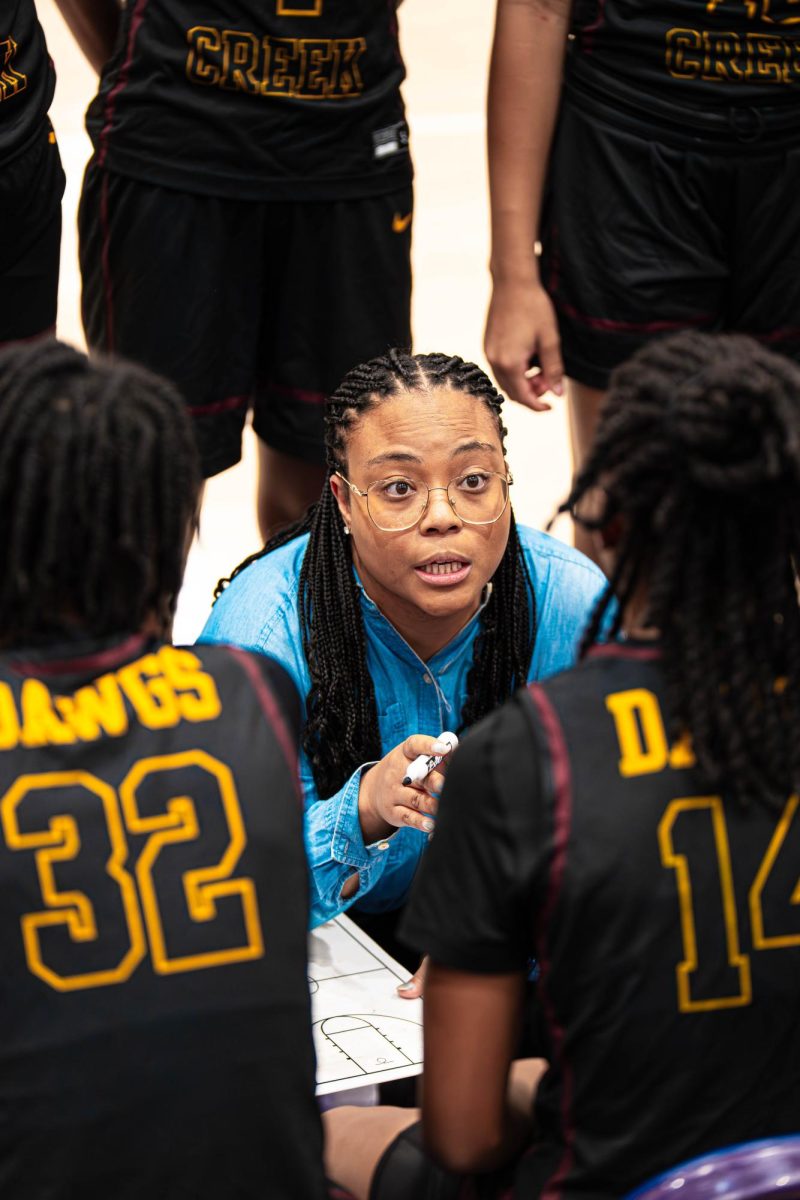 Coach Kiara Marshall runs plays with the team during a timeout. 