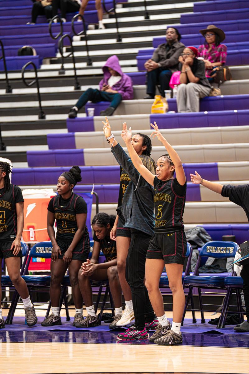 Junior Madison Mohammed cheers as her teammate and sister Peyton Mohammed scores a three-pointer. "I believe my energy supports the team by making sure everyone stays engaged and heard.," Mohammed said. "I really focus on motivating my teammates and acknowledging their efforts whether we're celebrating successes or working through tough moments.
